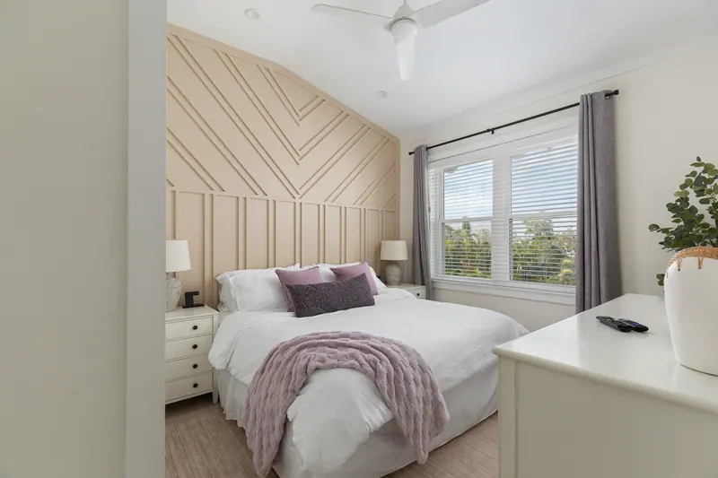 Guest bedroom with Roku TV and bedside charging stations