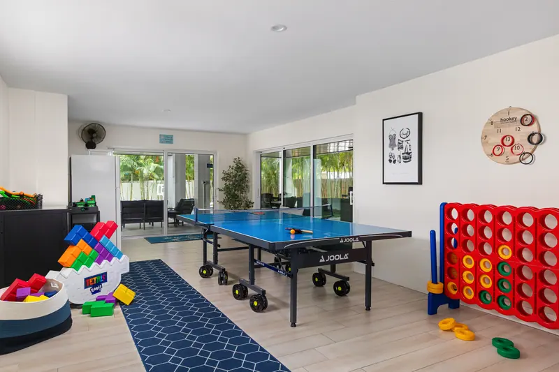 Lower-level game room with JOOLA ping pong, oversized Connect Four and a giant block stack