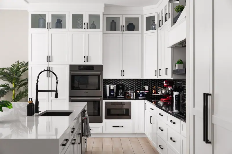 Bosch double ovens, microwave and paneled refrigerator in the main kitchen