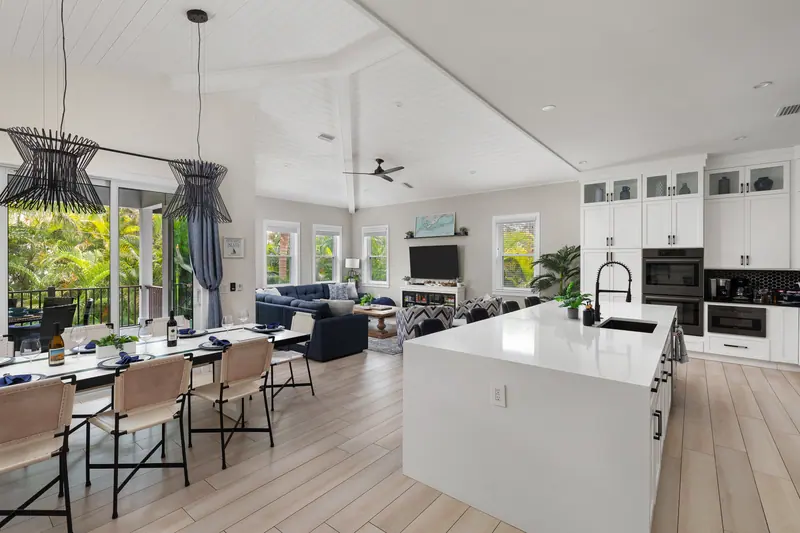 Open-concept kitchen, dining and lounge with tropical views