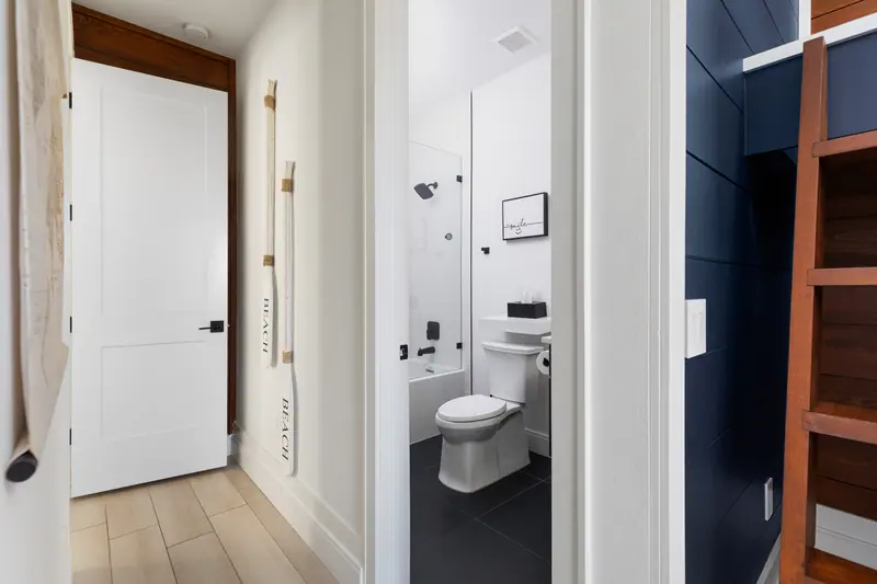 Bunk room en-suite with glass-enclosed shower and tub combo