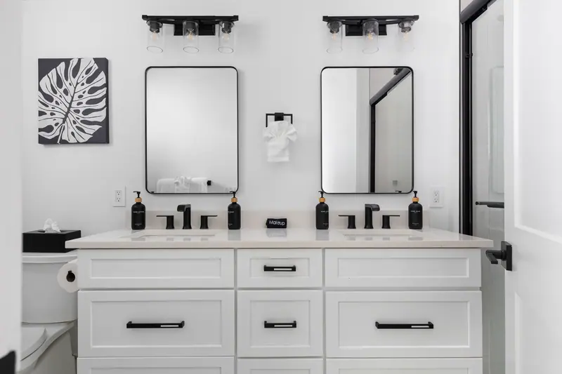 Spa-style en-suite with double vanity, matte black fixtures and walk-in shower