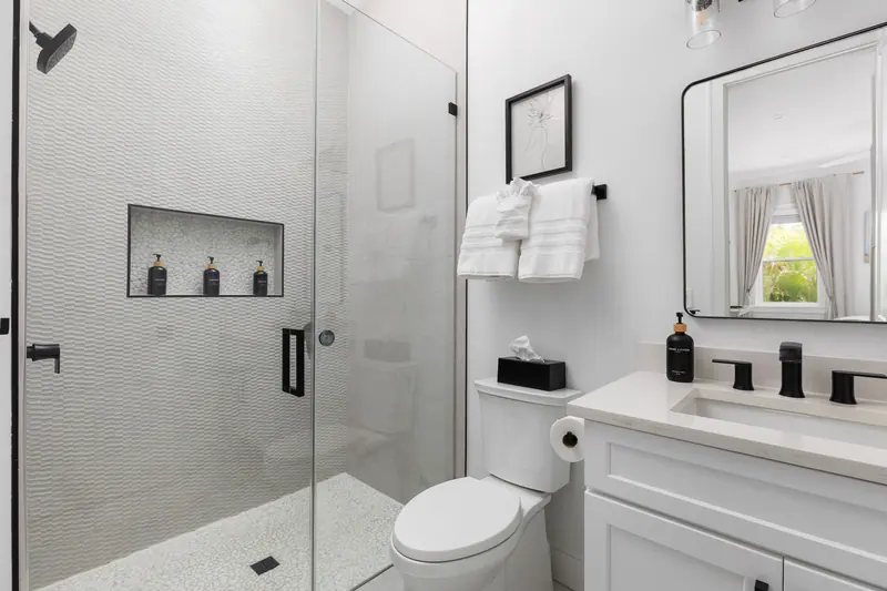 En-suite bath with glass walk-in shower and stocked amenities