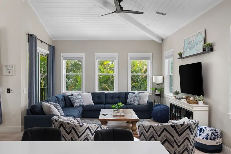 Living room with vaulted ceilings, plush sectional and Roku TV